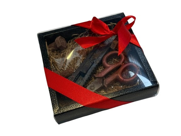Scatola con forbice, taglierino e bulloni in cioccolato